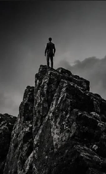 A person standing on a mountain peak